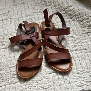 woman’s tan strapy sandals